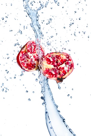 Fresh pomegranates with water splashing, isolated on white background の写真素材