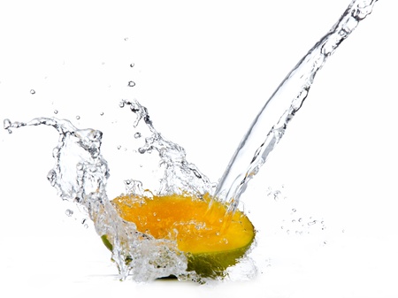 Fresh mango slice in water splash, isolated on white backgroundの写真素材