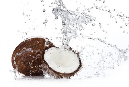 Fresh coconuts in water splash, isolated on white backgroundの写真素材