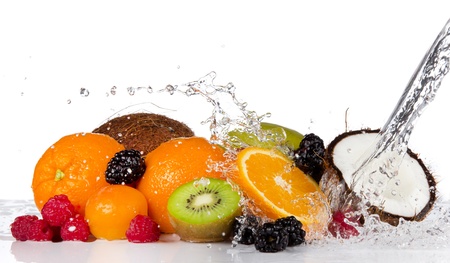 Fresh fruits pieces in water splash, isolated on white backgroundの写真素材