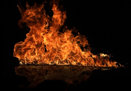 Fire flame with water reflectionの写真素材