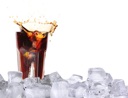 Ice splashing drink with ice cubes, isolated on white backgroundの写真素材