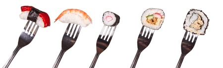 Sushi pieces on forks, isolated on white backgroundの写真素材