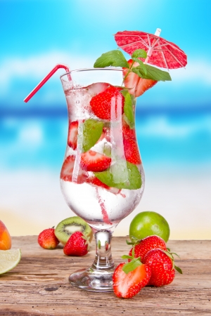 Strawberry mojito with blur beach on backgroundの写真素材
