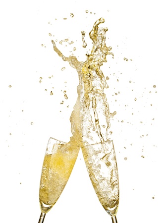 Splashing champagne out of glasses, concept of celebration  Isolated on white backgroundの写真素材