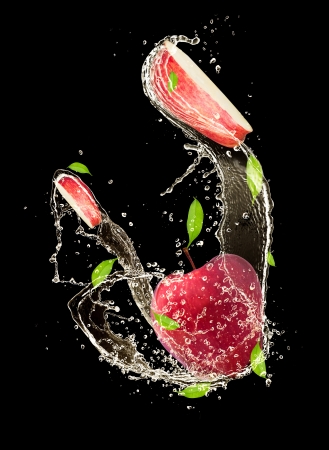 Red apples in water splash, isolated on black backgroundの写真素材