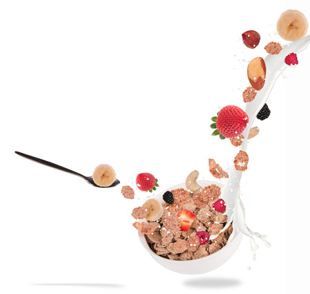 Healthy bowl with flying cereals and fruit, isolated on white background