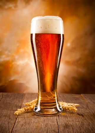 Glass of beer on woden tableの写真素材