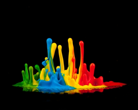 Colored splashes isolated on black backgroundの写真素材