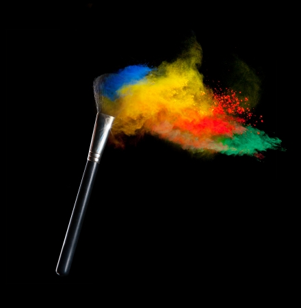Freeze motion of colored dust explosion with brush, isolated on black backgroundの写真素材