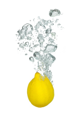 Isolated shot of lemon falling into water, isolated on white backgroundの写真素材