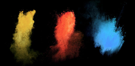 Freeze motion of colored dust explosion isolated on black background