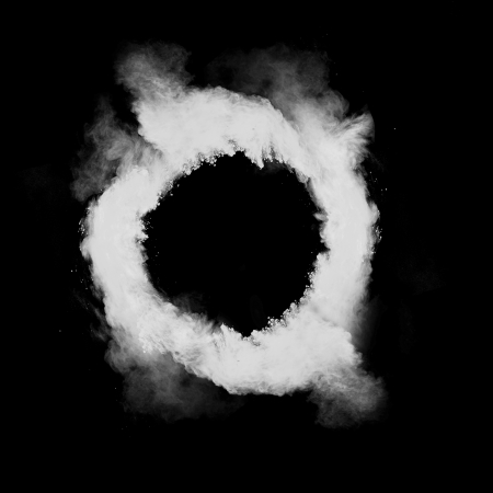 Freeze motion of white dust in round shape isolated on black backgroundの写真素材