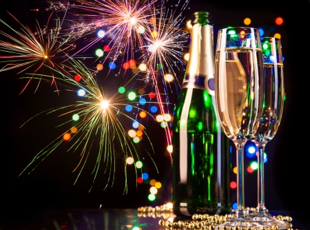 Champagne glasses with fireworks on backgroundの写真素材