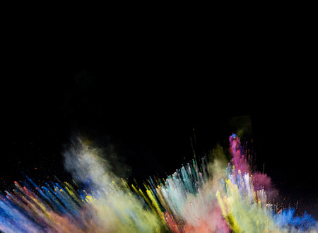 Freeze motion of colored dust explosion isolated on black backgroundの写真素材