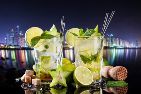 Summer drinks with blur night modern city on backgroundの写真素材