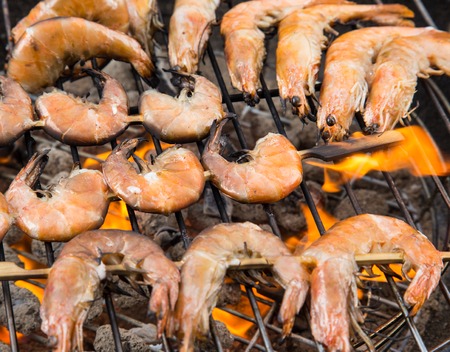 Delicious grilled prawns on burning coalsの写真素材