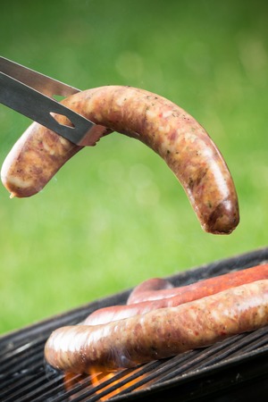 Delicious grilled sausages burning in fireの写真素材