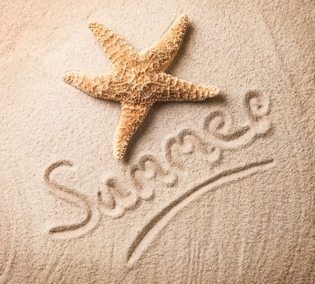 Holiday concept with inscription in sandの写真素材
