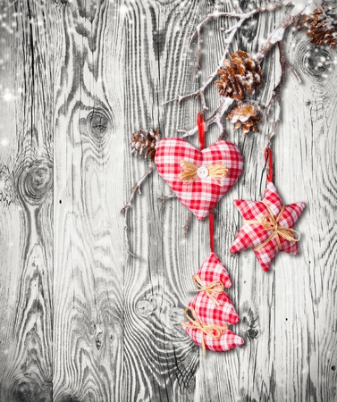 Home made traditional decoration on branch. Wooden planks as backgroundの写真素材