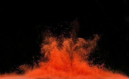 Freeze motion of colored dust explosion isolated on black backgroundの写真素材
