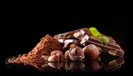 Pile of hazelnut chocolate isolated on black backgroundの写真素材