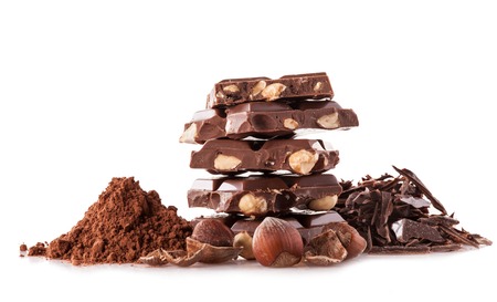 Pile of hazelnut chocolate isolated on black backgroundの写真素材