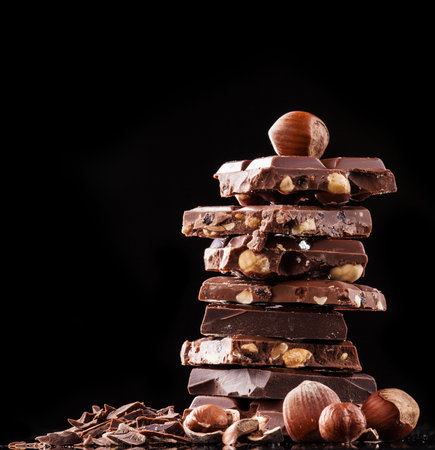 Pile of hazelnut chocolate isolated on black backgroundの写真素材