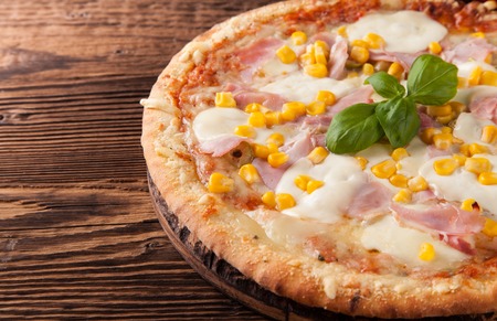 Delicious fresh pizza served on wooden tableの写真素材