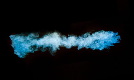 Freeze motion of blue dust explosion isolated on black 