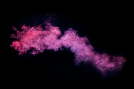 Freeze motion of pink dust explosion isolated on black の写真素材