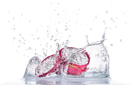 Fresh dragon fruit in water splash isolated on white backroundの写真素材
