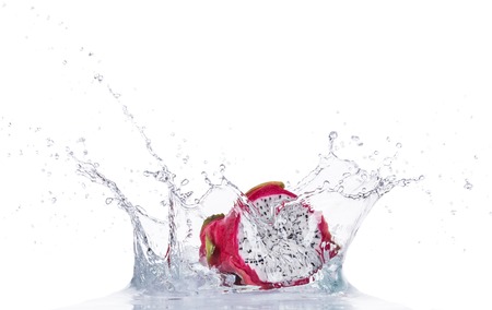Fresh dragon fruit in water splash isolated on white backroundの写真素材
