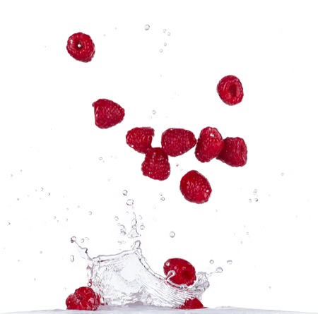 Raspberries in water splash isolated on white backgroundの写真素材