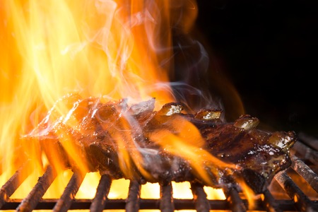 Ribs on barbecue grill in flamesの写真素材