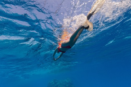 Freediver woman swimming on water surface and snorklingの写真素材