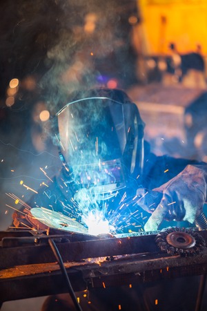 Close-up of welder working in workshop. Low depth of focusの写真素材