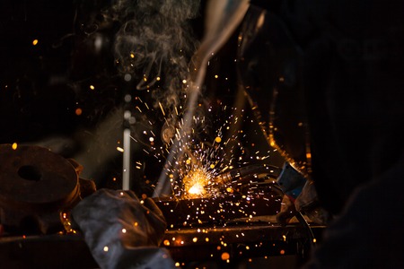 Close-up of welder working in workshop. Low depth of focusの写真素材
