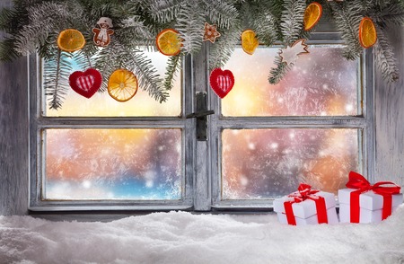Atmospheric Christmas window sill decoration with beautiful sunset viewの写真素材