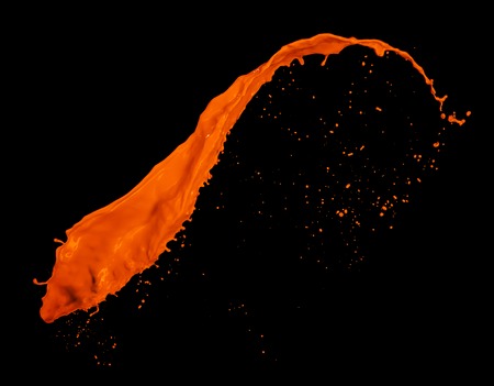 Orange paint splash isolated on black backgroundの写真素材