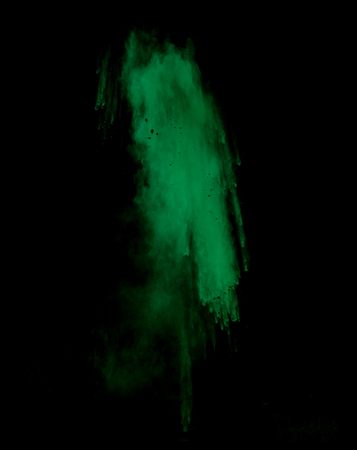 Freeze motion of green dust explosion isolated on black backgroundの写真素材