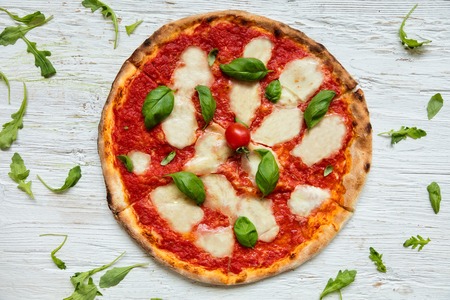Delicious italian pizza served on wooden table, shot from aboveの写真素材