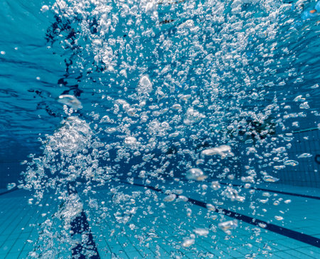 Air bubbles in clear blue water in pool. Underwater photography