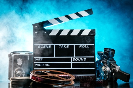 Retro film production accessories still life. Concept of filmmaking. Smoke effect on backgroundの写真素材