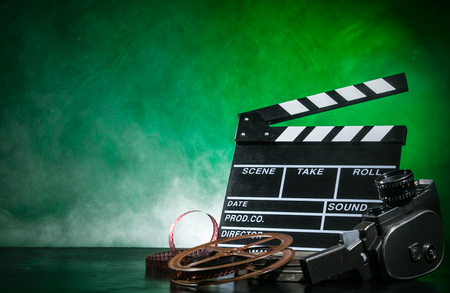 Retro film production accessories still life. Concept of filmmaking. Smoke effect on backgroundの写真素材