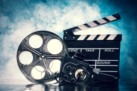 Retro film production accessories still life. Concept of filmmaking. Smoke effect on backgroundの写真素材