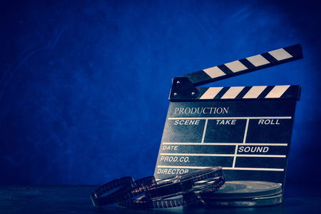 Retro film production accessories still life. Concept of filmmaking. Smoke effect on backgroundの写真素材