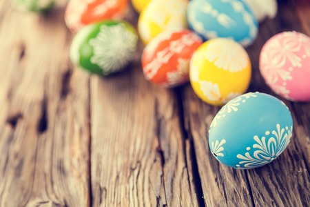 Colorful easter eggs placed on wooden backgroundの写真素材