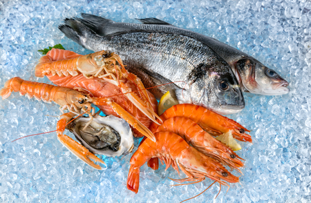 Various kind of fresh seafood placed on ice driftの写真素材