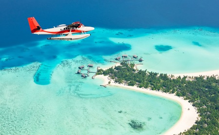 Sea plane flying above Maldives islands, Raa atolの写真素材